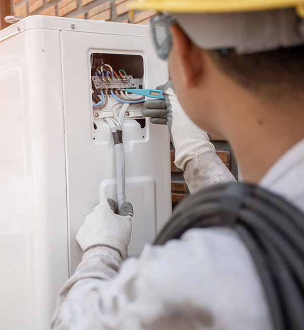 Technician repairing an outdoor unit Technician repairing an outdoor unit