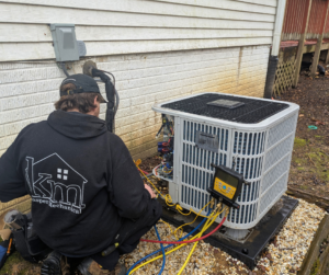 A technician performing maintenance on a heat pump.