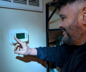 A Kasper Mechanical Technician checking a thermostat.