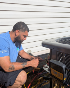An HVAC technician inspecting a heat pump in Spotsylvania VA.