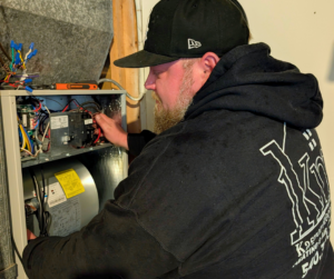 A HVAC service technician replacing a heating system.
