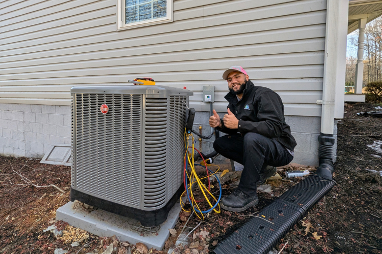 Customer Care Club A technician performing maintenance on a heat pump.